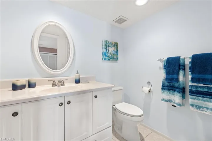 Bathroom with tile patterned floors, vanity, and toilet