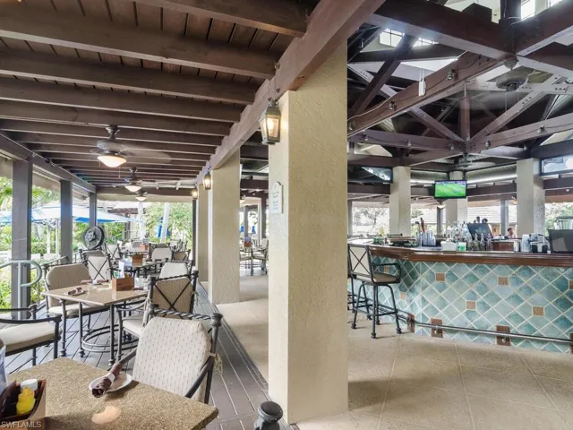 View of patio / terrace with a bar and ceiling fan