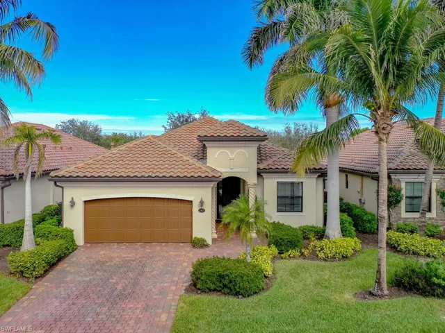 Mediterranean / spanish-style house featuring a front lawn and a garage