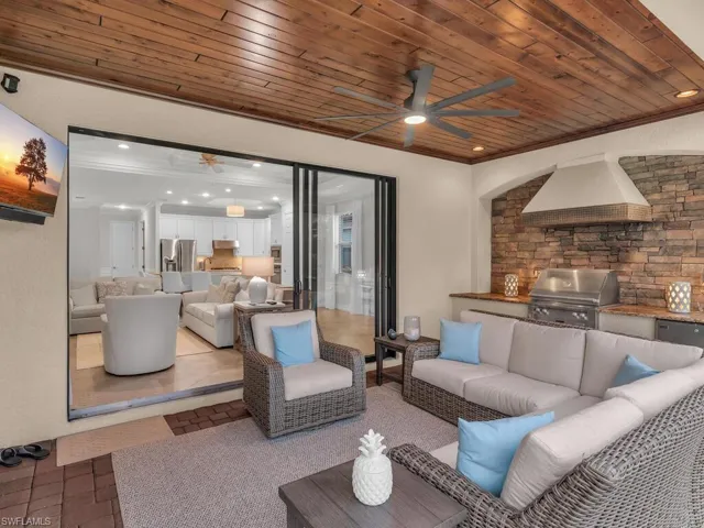 Living room with crown molding and wooden ceiling