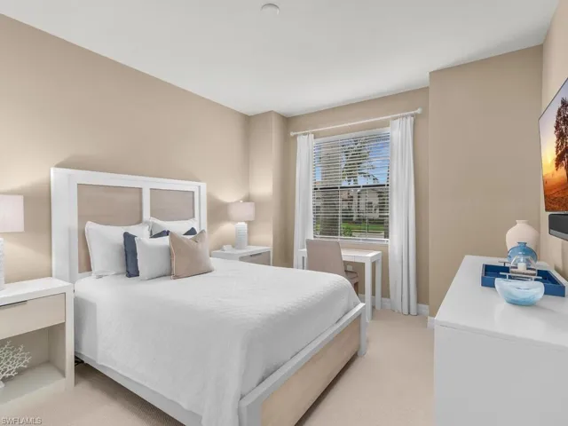 Bedroom featuring light carpet