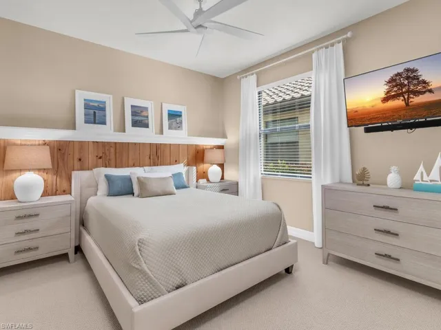 Carpeted bedroom featuring ceiling fan