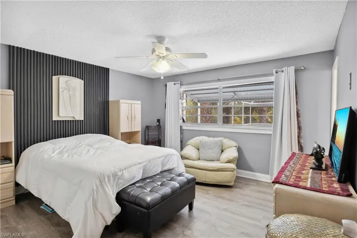 The spacious primary bedroom offers a serene retreat with ample natural light and peaceful views.