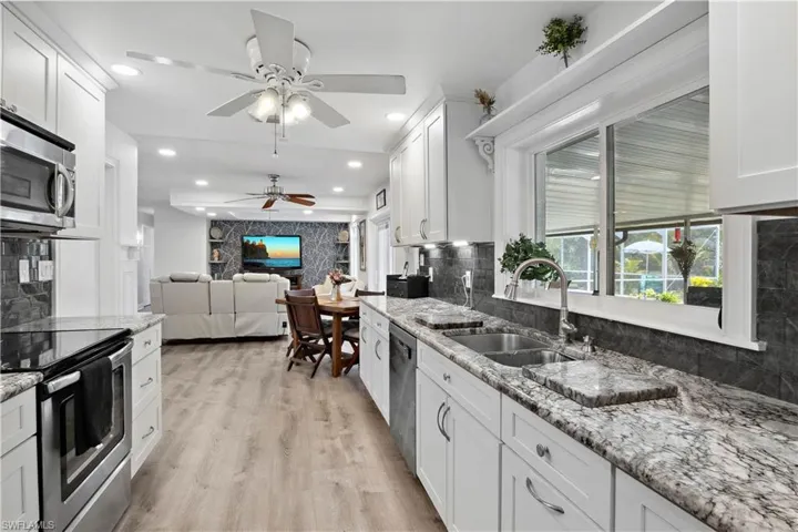 The heart of the home is a chef-friendly kitchen featuring quality cabinetry, generous counter space, and a seamless flow to the living room.
