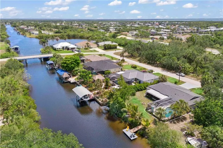 Gulf-access beauty with lush landscaping and timeless style.