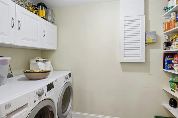 The spacious laundry room offers ample room for sorting, folding, and storage.