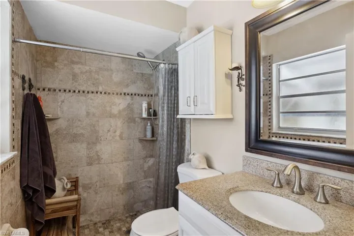 The primary bath showcases a beautifully tiled walk-in shower designed for comfort and style.