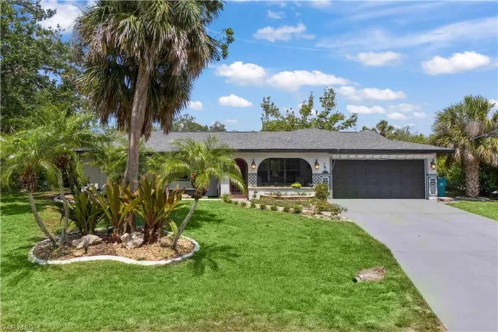 Renovated elegance, vibrant gardens, and serene water views!