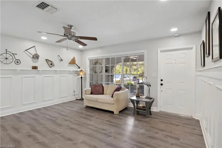 The inviting sitting area features comfortable space to relax, chat, or read, making guests feel instantly welcome.