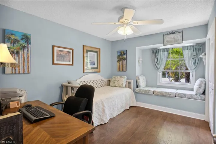 A versatile guest bedroom with a bright sitting nook that’s perfect for use as a home office or relaxation spot.