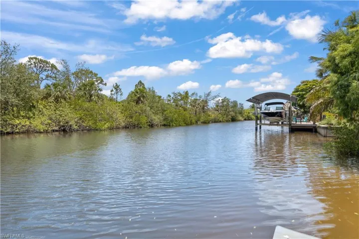 The dock extends over calm waters, offering stunning panoramic views that stretch as far as the eye can see.