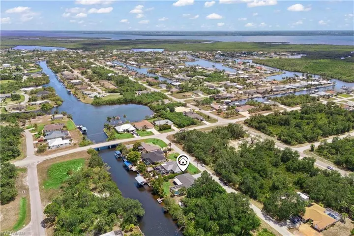 This stunning aerial view captures the home’s premier location along navigable canals that lead directly to the ocean.