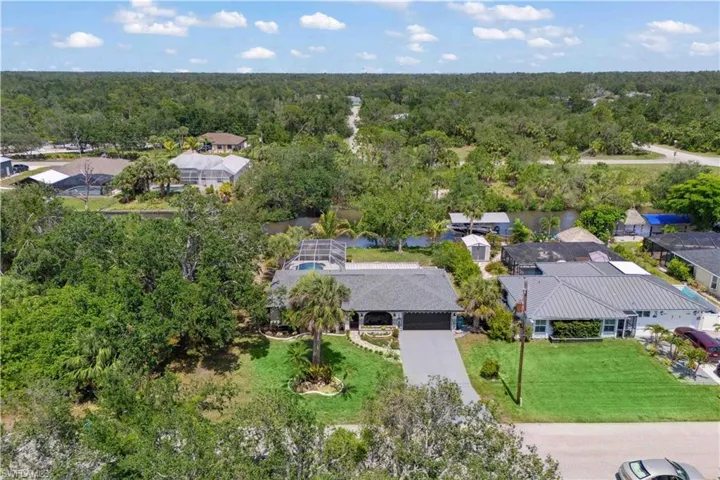See the full scope of the property’s stunning front yard, complete with colorful plantings and a spacious driveway.