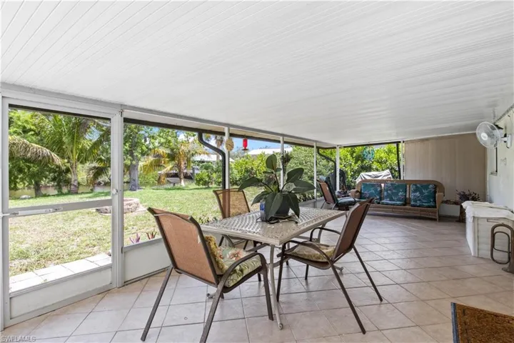 Enjoy morning coffee or evening cocktails on the charming patio surrounded by tropical greenery and canal views.