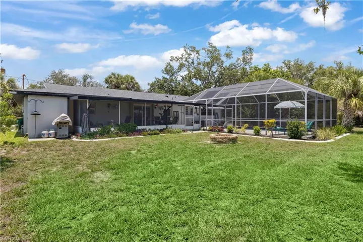 Views of the backyard and pool showcase a lush, tropical setting designed for comfort and fun.