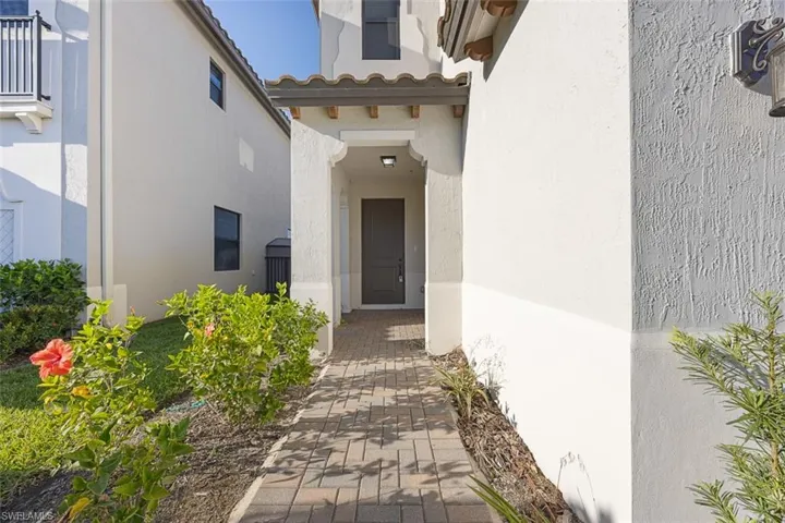 Doorway to property with stucco siding and a tiled roof