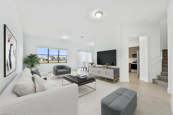 Virtually Staged-Living area featuring stairs and light tile patterned floors