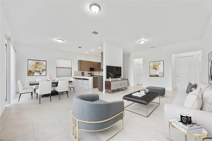 Virtually Staged-Living area featuring light tile patterned floors, recessed lighting, and visible vents