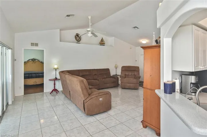 Notice the high vaulted ceiling in the tiled Great Room, with plant shelf for your home decor!