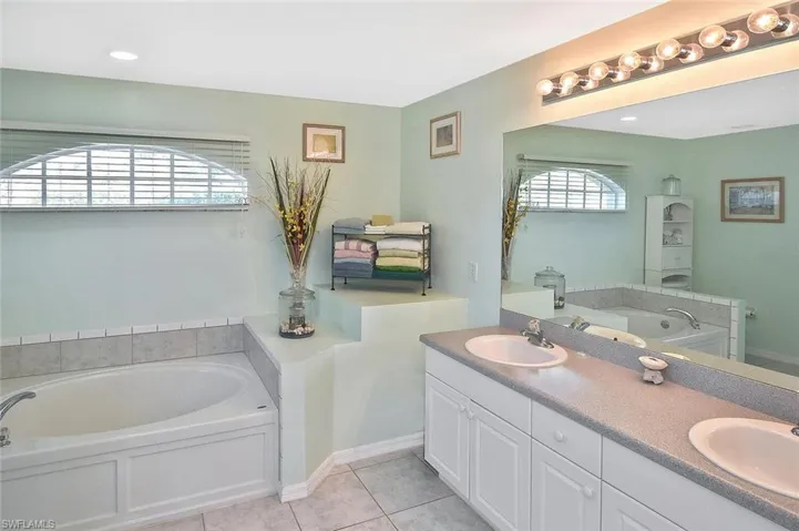 Owner's Suite bath is comfortably spacious, and features dual sinks, a large Roman tub...