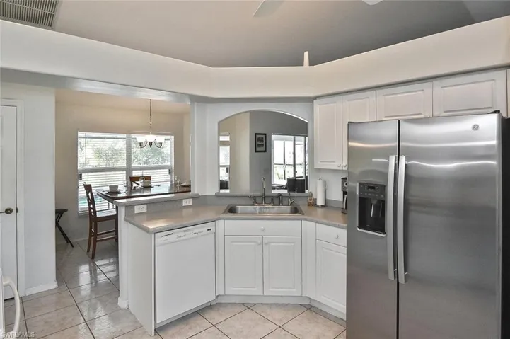 The large kitchen with raised-panel white cabinetry is light and bright...