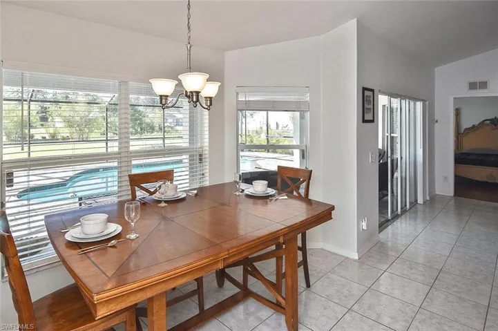 ...with a spacious eat-in area overlooking the pool and pavered lanai.