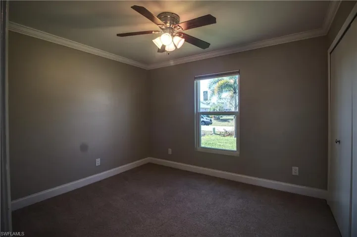 Guest bedroom 2 featuring crown molding and ceiling fan