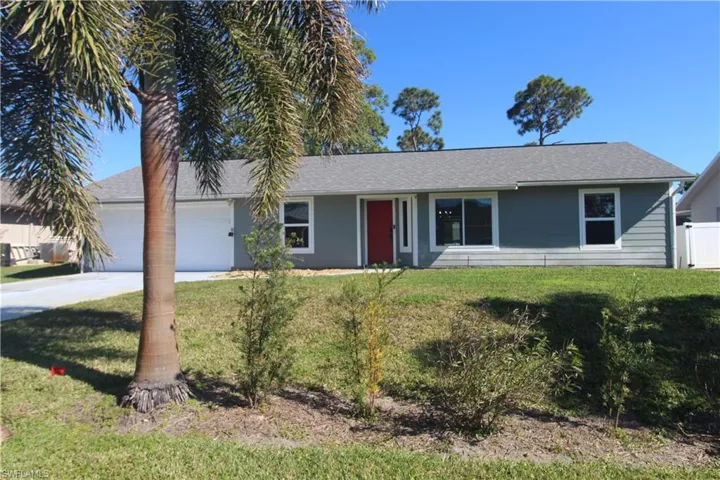 Ranch-style house with a garage and a front yard