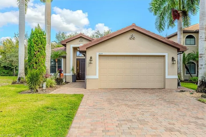 Mediterranean / spanish-style house featuring stucco siding, decorative driveway, a front yard, and an attached garage