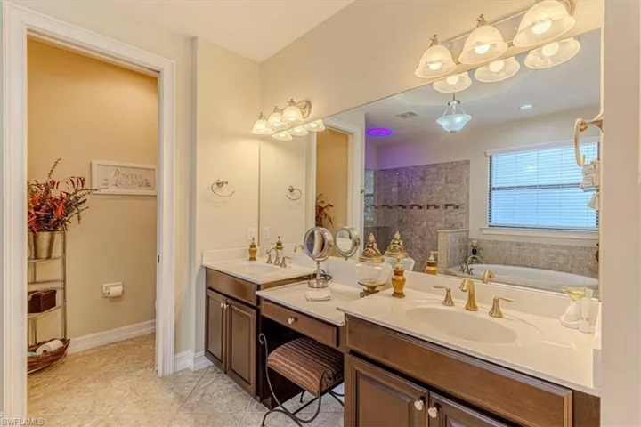 Master Full bath with a bath, double vanity, light tile patterned floors, and a walk in shower
