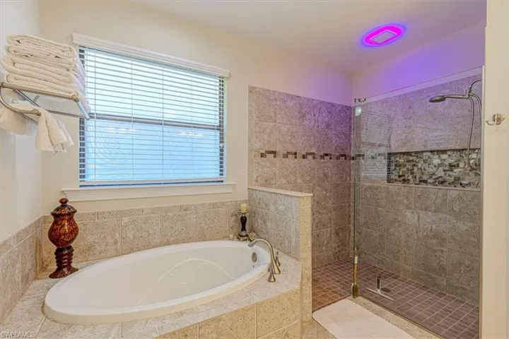 Master Bathroom featuring a garden tub and a walk in shower