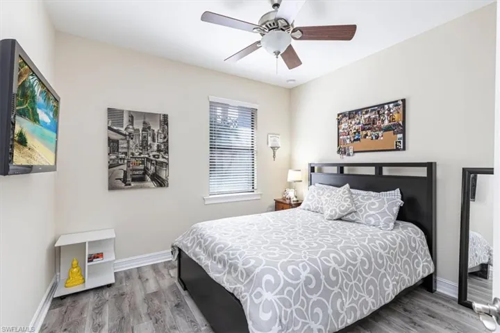 Bedroom with light wood finished floors and ceiling fan