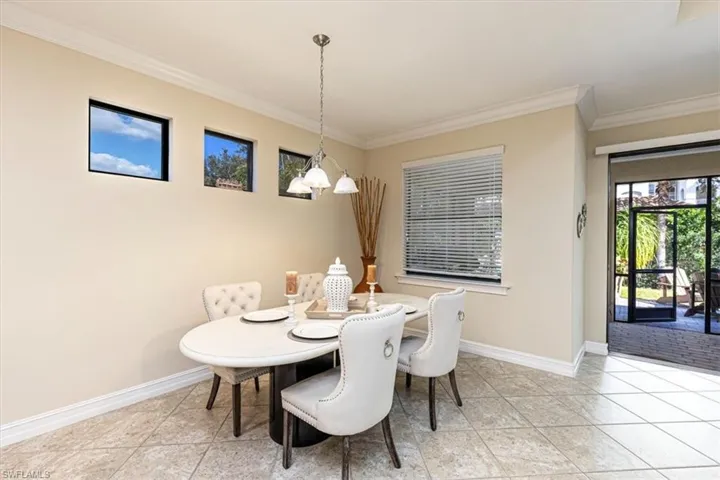 Dining area featuring ornamental molding, plenty of natural light, and light tile patterned floors
