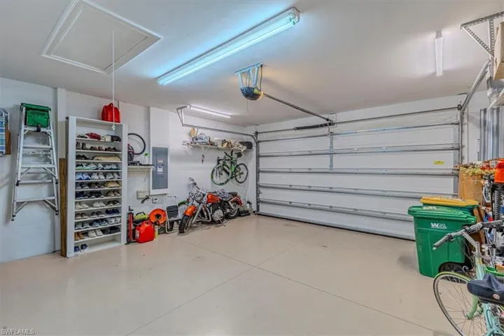 Garage featuring electric panel and a garage door opener