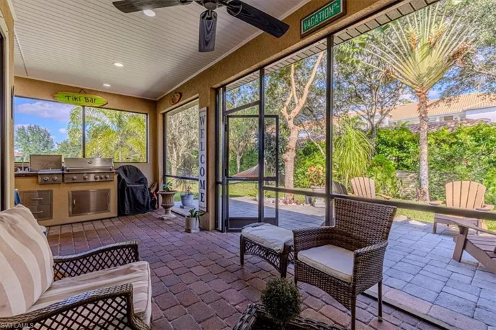 Sunroom / solarium featuring exterior kitchen and ceiling fan