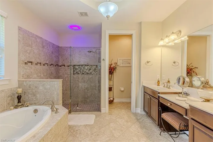 Master Full bath featuring a bath, double vanity, and a walk in shower
