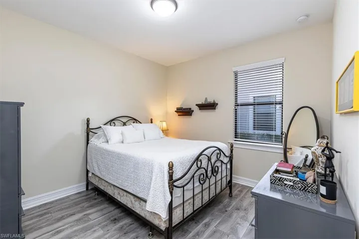 Bedroom with light wood-style floors and baseboards