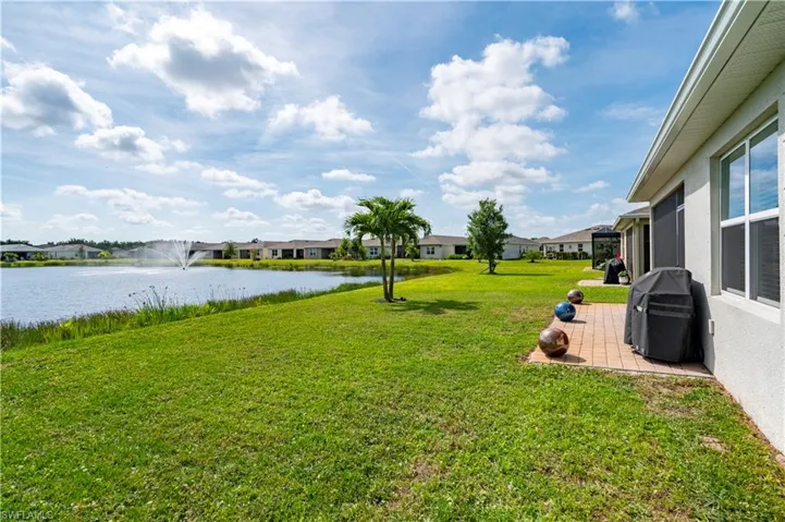 Back of home with view of lake