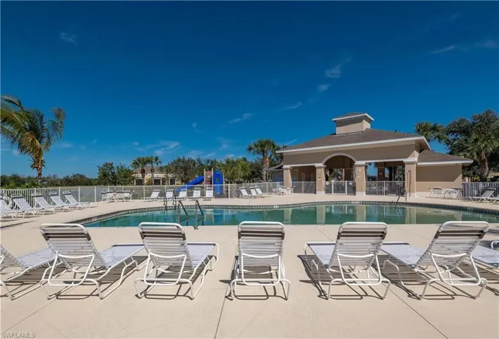 Heated community pool with shaded area and restrooms