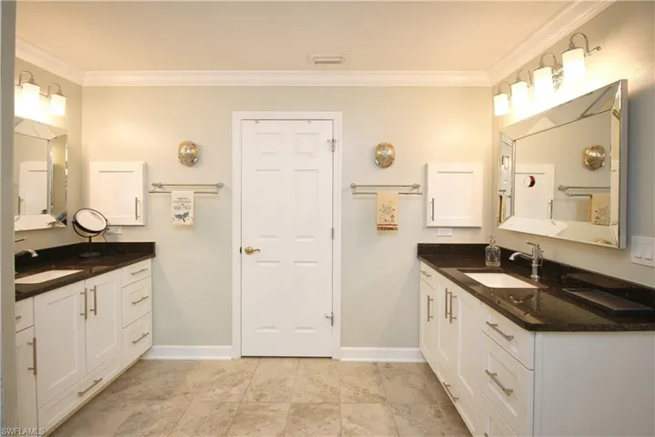 Primary Suite Bathroom with Dual Sinks and Large Walk-in Closet