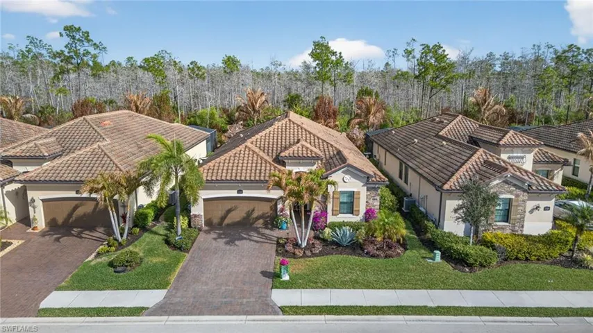 Mediterranean / spanish-style house featuring stucco siding, a garage, decorative driveway, and a tiled roof