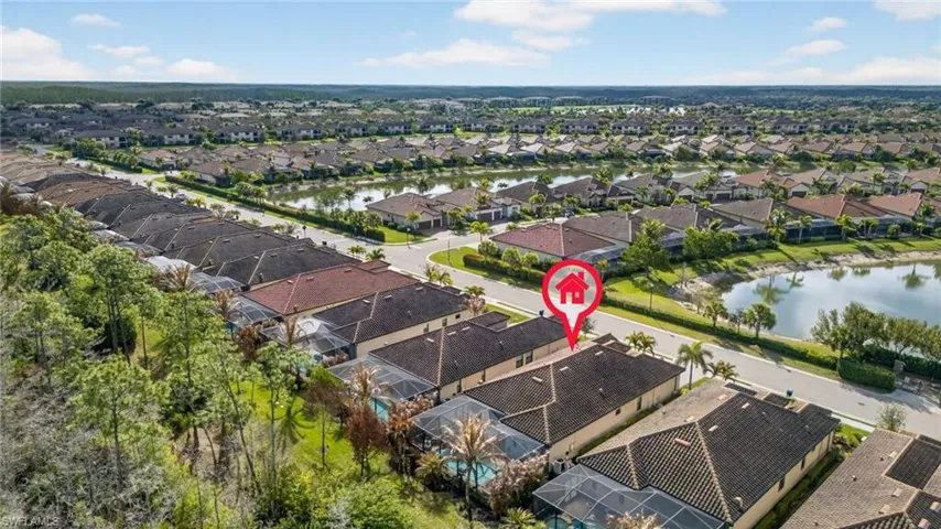Aerial view of residential area featuring a nearby body of water