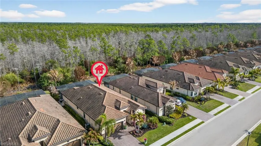 Aerial perspective of suburban area featuring a forest