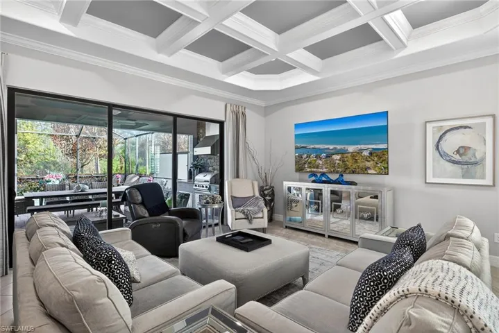 Living room with ornamental molding and coffered ceiling