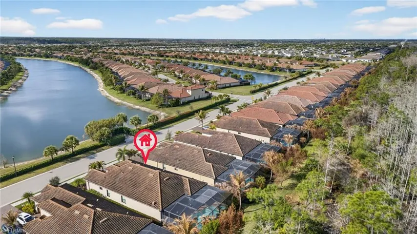 Aerial perspective of suburban area with a nearby body of water