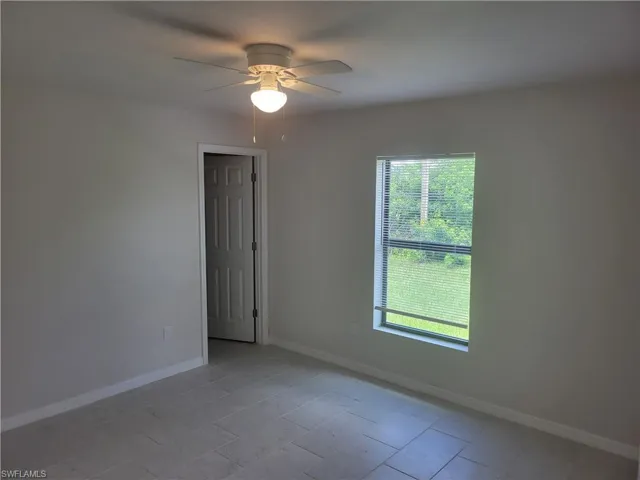 Unfurnished room featuring ceiling fan and light tile patterned floors