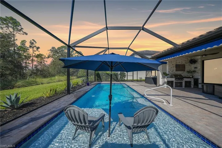Welcome home!   Wow, This set up epitomizes Florida Living with your very own private pool, summer kitchen and serene private nature views