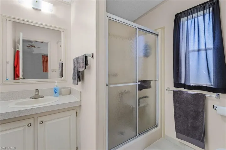 Full bathroom with a stall shower and vanity