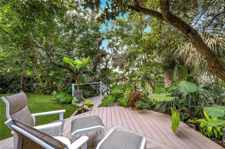 Backyard is a private haven adorned by lush landscaping and live oak trees!