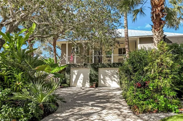 Welcome home to 9976 Puopolo Lane...one of Bonita's most private and STUNNING river side streets.